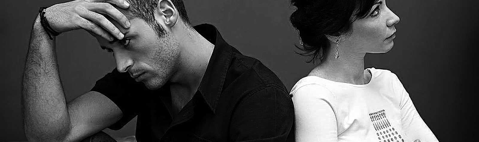 Una pareja hombre-mujer dándose la espalda. Foto en blanco y negro.